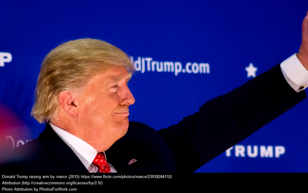 Donald trump waving at an event